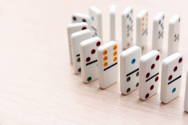 istock white dominoes stand in a row on a light surface, close-up 1202459798
