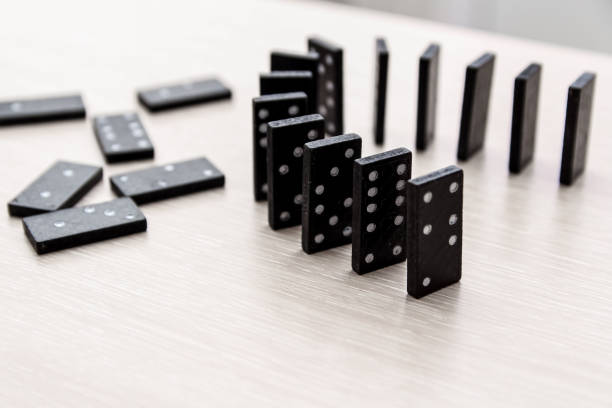 istock black dominoes on a light wooden table stand in a row 1202459929