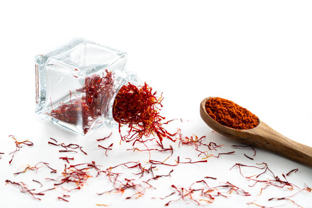 istock Saffron spice in glass bottle isolated on white 1202460268