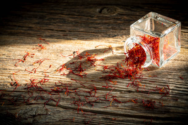 istock Saffron spice in glass bottle on rustic wooden table 1202460334