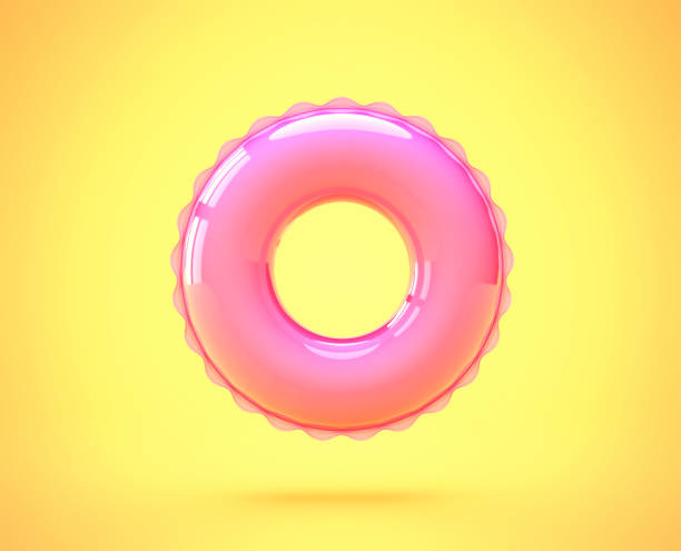 pink inflatable swimming ring isolated on yellow - swim ring imagens e fotografias de stock