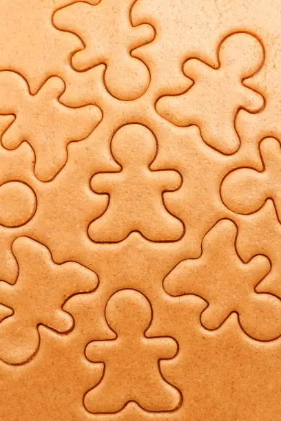 Gingerbread men cookies background. Christmas dough baking pattern