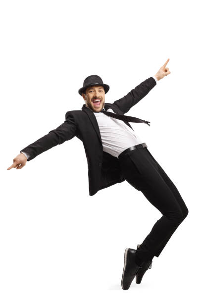 istock Smiling guy in a suit dancing and pointing with fingers 1202463637