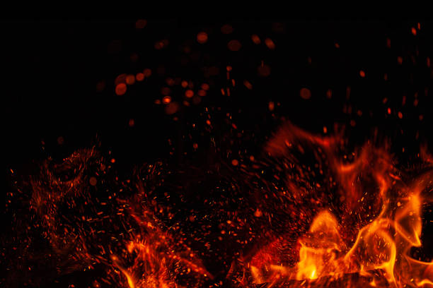 istock Blazing fire and sparks isolated on black background 1202464553