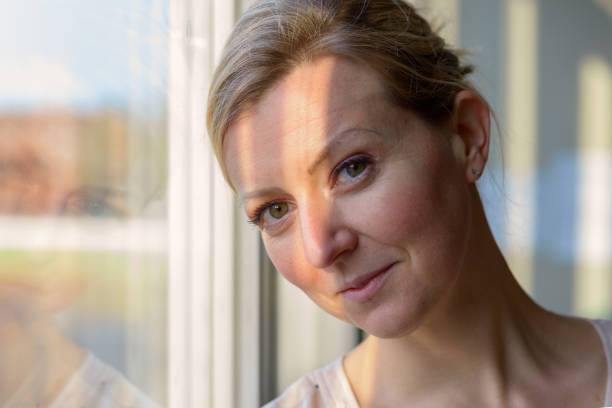 istock Quizzical blond woman with a knowing smile 1202465078