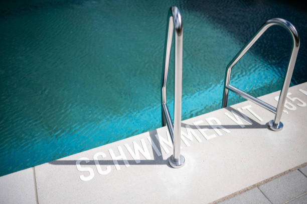 Legs of a young woman in a swimming pool on a sunny day