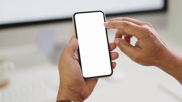 istock Close up view of male freelancer typing  smartphone while sitting in workspace 1202467051