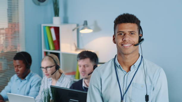 istock Portrait of multiracial customer service operator in headset smiling to the camera 1202467145