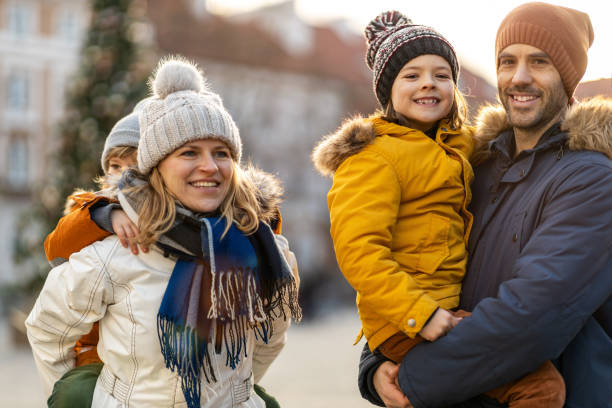 istock Happy young family having fun outdoors during Christmas 1202468719