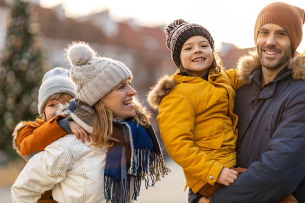 istock Happy young family having fun outdoors during Christmas 1202468843