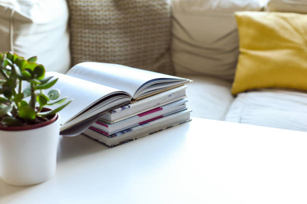 3D Beige armchair with stack of books and coffee cup. Home library. Reading as hobby. Cosy hygge aesthetics. House interior. Cartoon creative design composition illustration. 3D Rendering