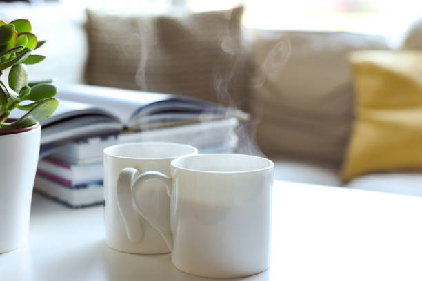 Relaxing sofa area with coffee table and hot drink in modern home interior