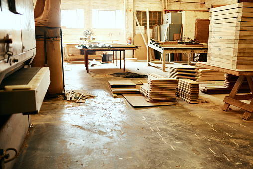 Still life shot of piles of wood stacked inside a carpentry workshop