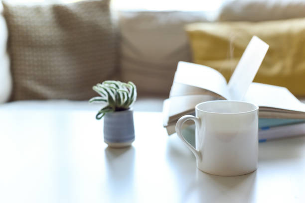istock Relaxing sofa area with coffee table and hot drink in modern home interior 1202471106