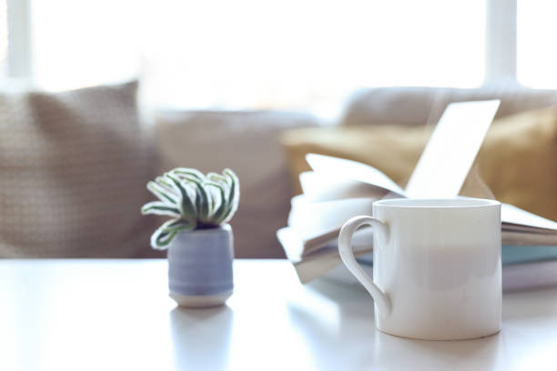 istock Relaxing sofa area with coffee table and hot drink in modern home interior 1202471917