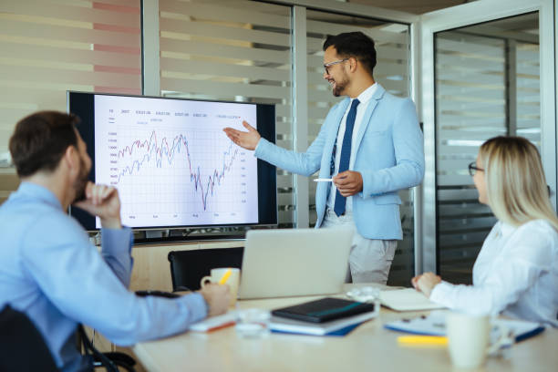 istock Young male executive leading presentation in meeting room 1202473981