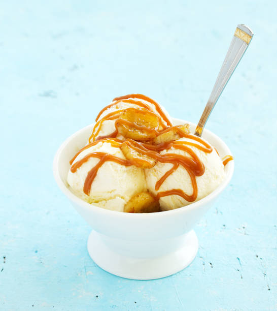 istock vanilla ice cream with bananas and caramel in a bowl. 1202474726