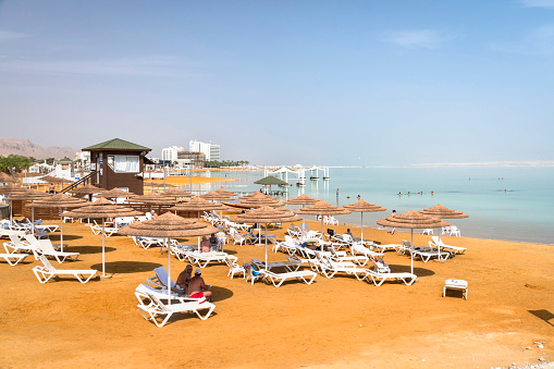 Sun beds, chairs, umbrellas and awnings on the beach luxury hotel on the Dead Sea in Israel. Ein Bokek. November 22, 2018