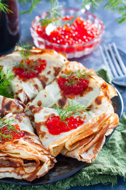 istock Low carb pancakes with caviar and fresh herbs, selective focus 1202475714