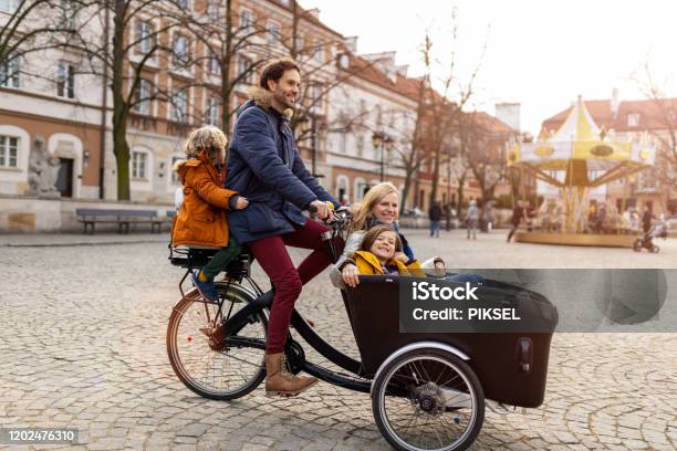 Young Family Enjoying Spending Time Together Riding In A Cargo Bicycle Stock Photo - Download Image Now