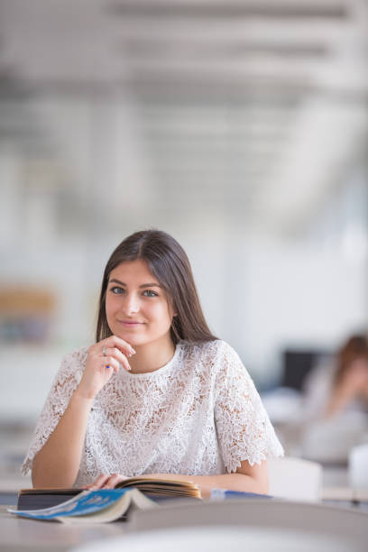istock Pretty, young college student looking for a book in the library 1202476568