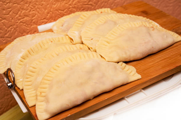 istock raw meat pies on a wooden board in the kitchen 1202477268