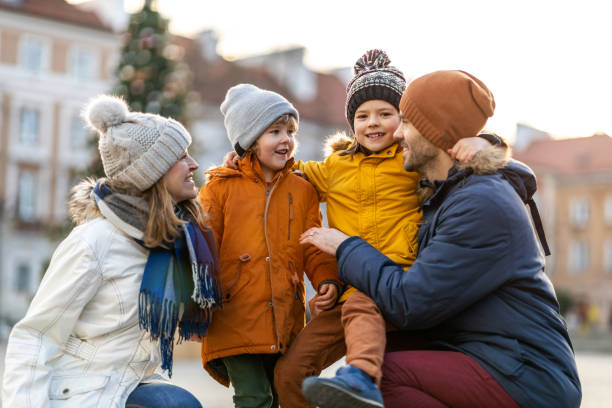 istock Happy young family having fun outdoors during Christmas 1202477375