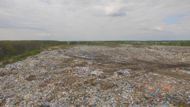 istock Aerial view of huge city garbage dump at forest. 1202477976