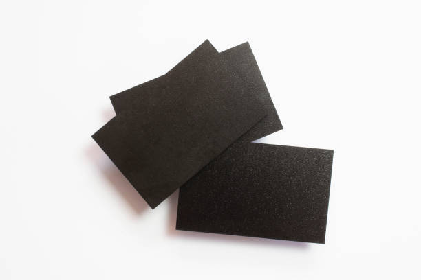 istock Three blank black textured business cards isolated on white, composition concept for presentation, studio shot. 1202478461