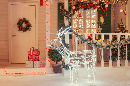 Vintage decorated Christmas building with illuminated deer