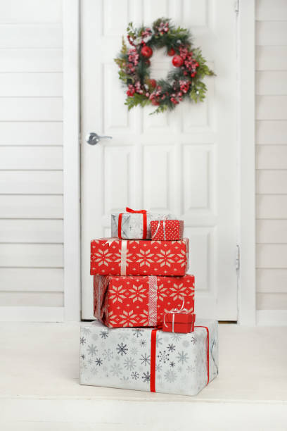 Christmas gift boxes delivered Christmas gift boxes delivered to vintage house door with wreath decoration front stoop photos stock pictures, royalty-free photos & images