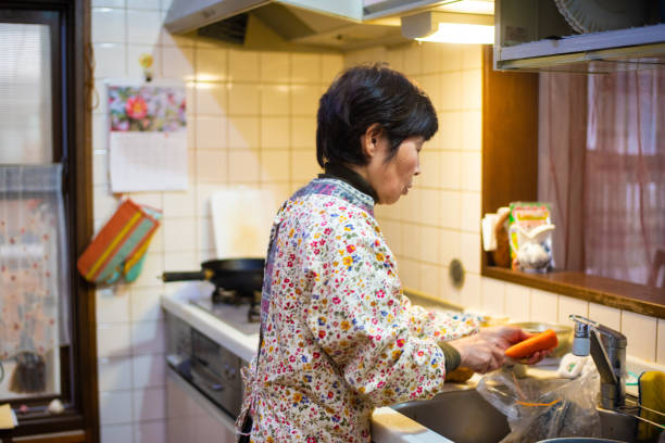 istock Senior woman preparing dinner 1202479855
