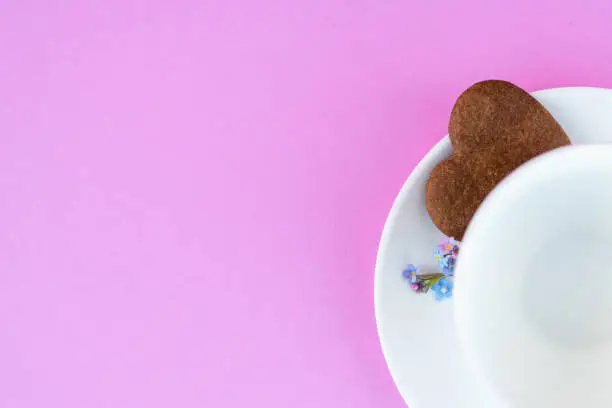 Coffee mug on a pink background. background Breakfast, drinks and cafe menu concept - coffee cup on purple background, toplay flatlay. cookies to coffee. White mug. copy space.