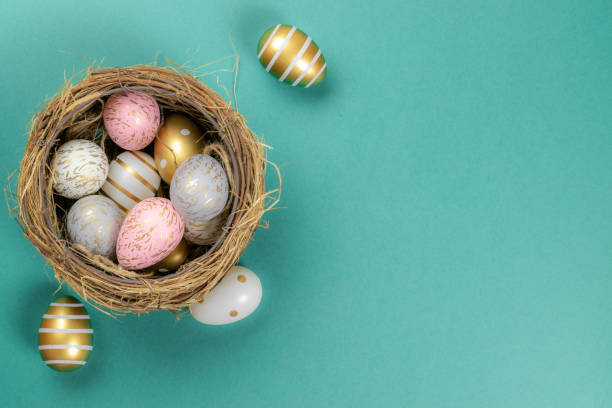 istock Easter egg background with golden shine decorated eggs in basket isolated on turquoise. Happy Easter. 1202480935