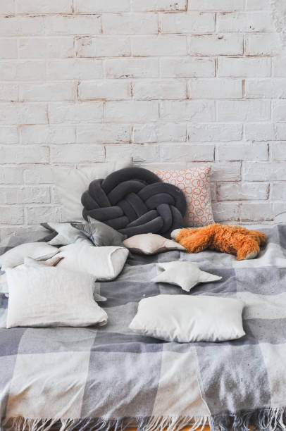 istock Cozy comfortable place for relax with pillows and plaid. 1202481661