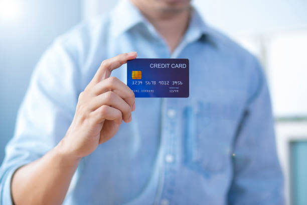 istock Man hand holding front credit card wear shirt 1202482121