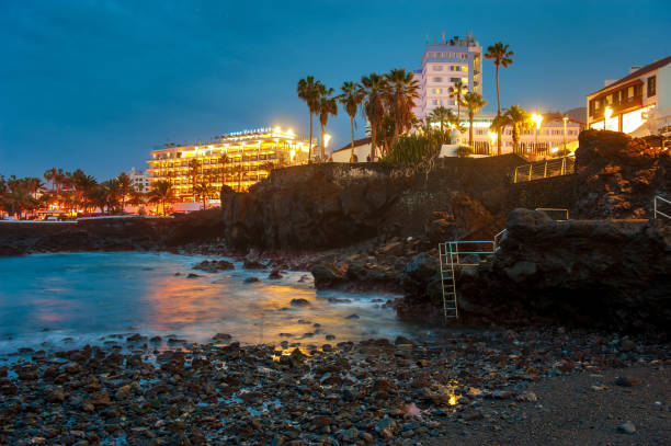 Port of the Cross Canary island Tenerife, Spain - 25 December, 2019: Volcanic rocks on the coastline of Puerto de la Cruz on Canary island Tenerife. puerto de la cruz tenerife stock pictures, royalty-free photos & images