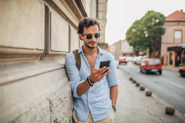 istock Man using mobile phone in the city 1202484912