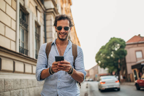 istock Handsome man using mobile phone in the city 1202485032