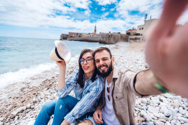 istock Young couple resting on beach 1202485089