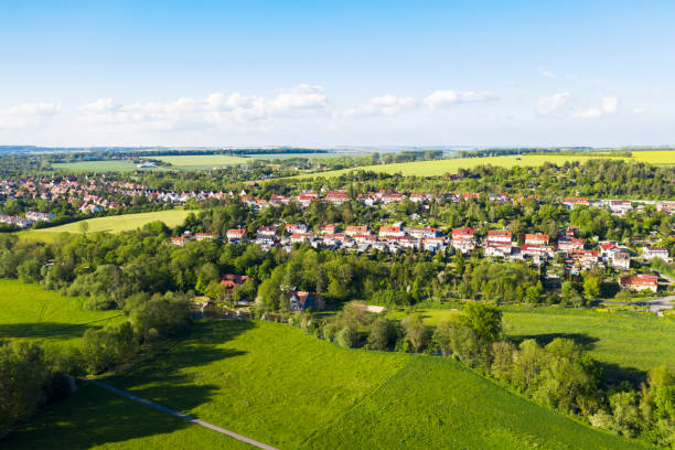 istock High angle view of a village and Agriculture fields in Germany 1202485325