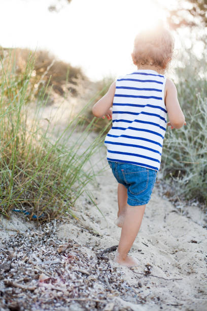 istock cute girl walking at he beach 1202485405