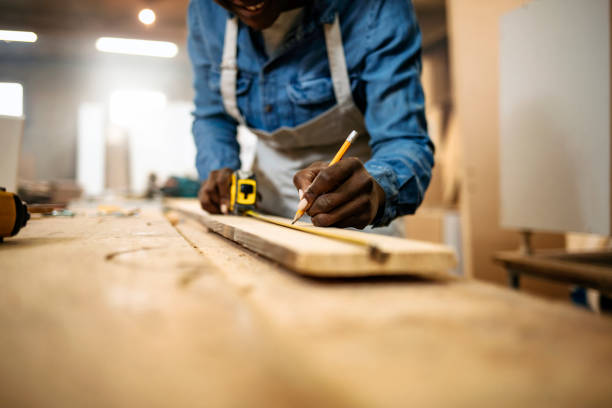 istock Close up of female carpenter working in workshop 1202485825