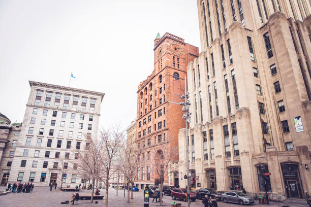 Place d'Armes is famous square in Montreal, Quebec, Canada. The centre of this square houses the monument Paul de Chomedey, also known as founder of Montreal. The buildings around this square includes Notre Dame Basilica, New York Life Building, Bank of Montreal HQ, 500 Place D’Armes and Saint Sulpice Seminary.