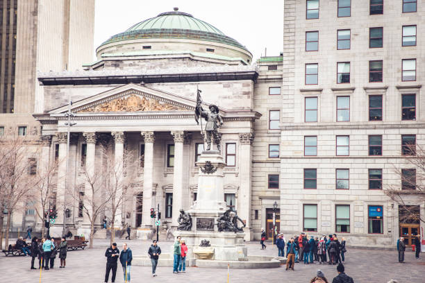 Place d'Armes Sqaure, Old Montreal, Quebec, Canada Place d'Armes is famous square in Montreal, Quebec, Canada. The centre of this square houses the monument Paul de Chomedey, also known as founder of Montreal. The buildings around this square includes Notre Dame Basilica, New York Life Building, Bank of Montreal HQ, 500 Place D’Armes and Saint Sulpice Seminary. place darmes montreal stock pictures, royalty-free photos & images