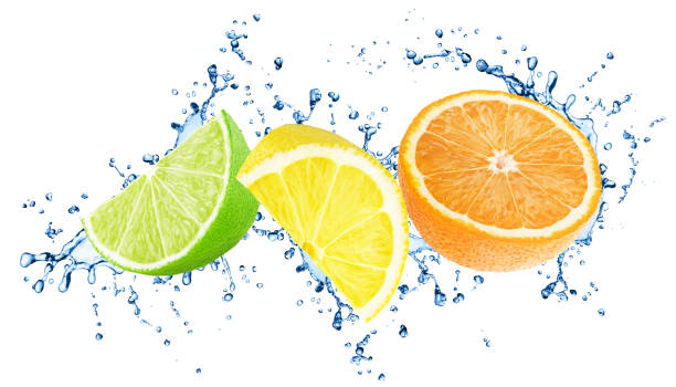 istock Cutted citrus fruits with water splashes isolated on white background. 1202487902