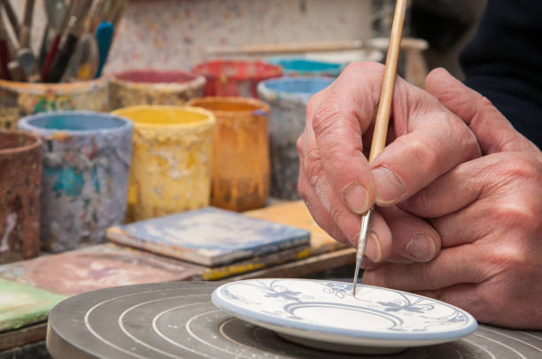 Close up shot of senior man hands making clay pot