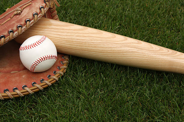istock Baseball bat, ball and glove laying in the grass 120248940