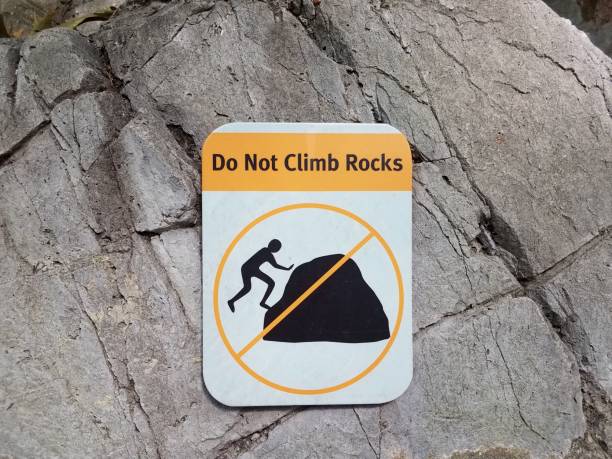 istock do not climb rocks sign on grey rock 1202491043