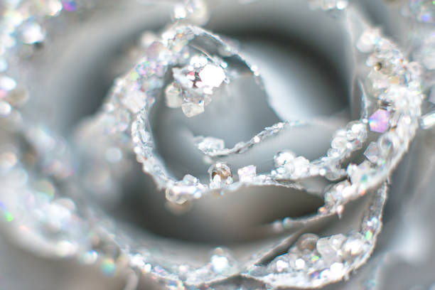 Shiny silver background with beads and precious stones and rhinestones. Selective focus, bokeh.